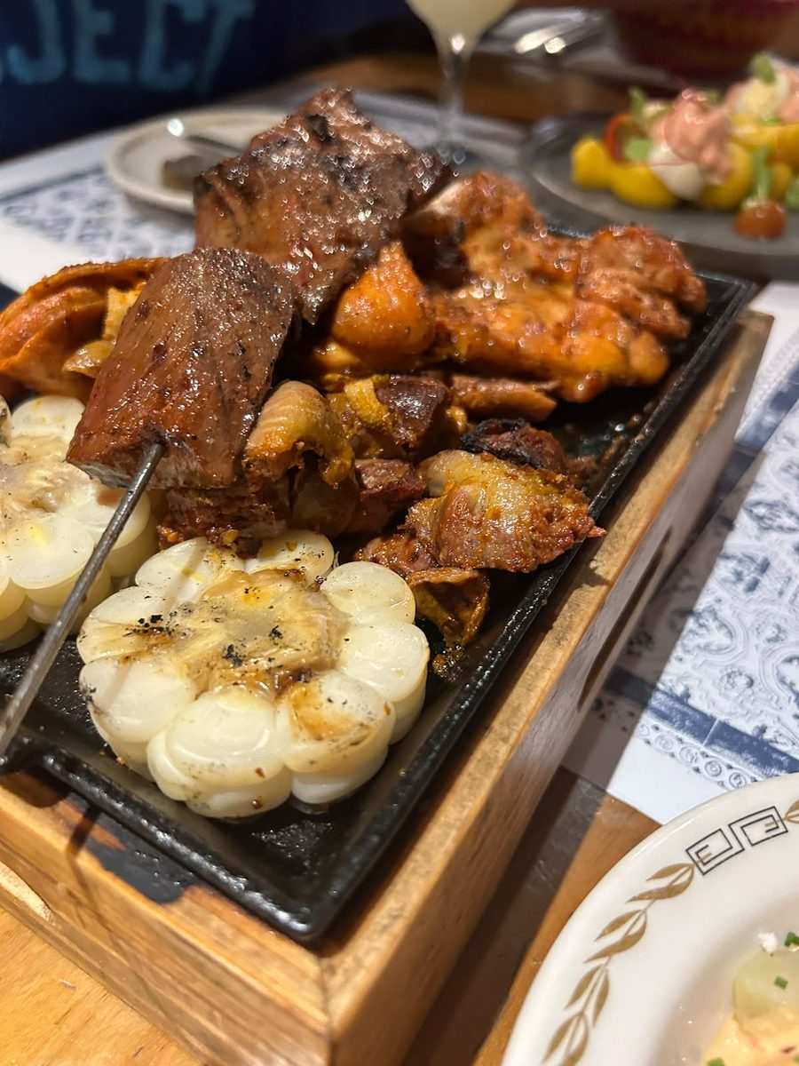 Anticucho grilled on a hot stone, with choclo