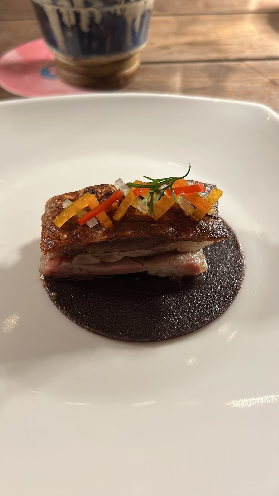 Slow-cooked pork belly on a dark sauce