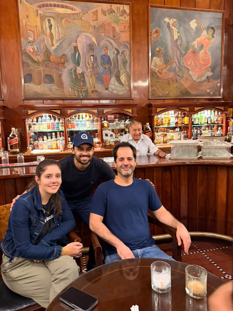 Guests at the bar of Bar Cordano, under its painted murals