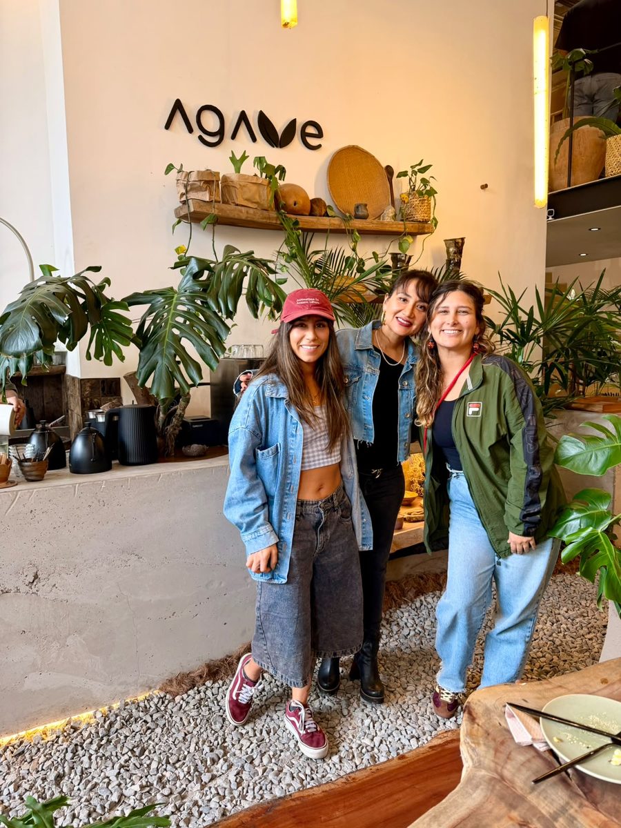 Three guests outside a café in Lima on a bright afternoon